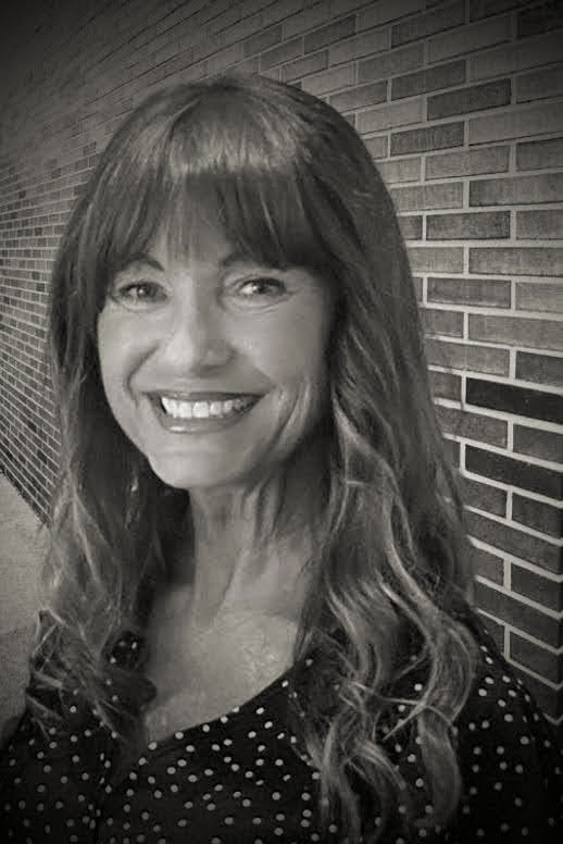 woman in front of brick wall