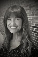 woman in front of brick wall